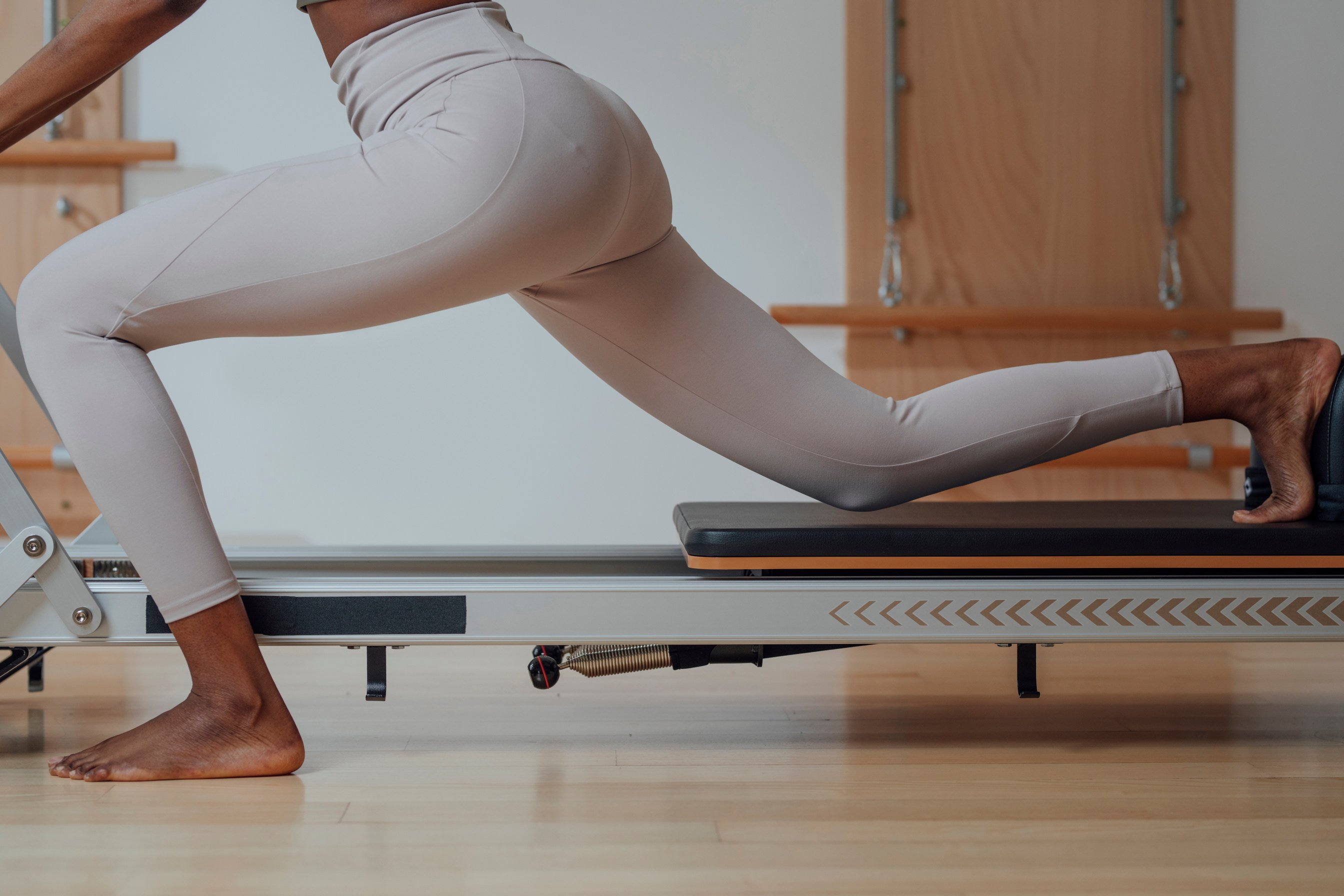 Woman Doing Pilates Exercise on Reformer